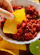 chip dipped into cranberry salsa